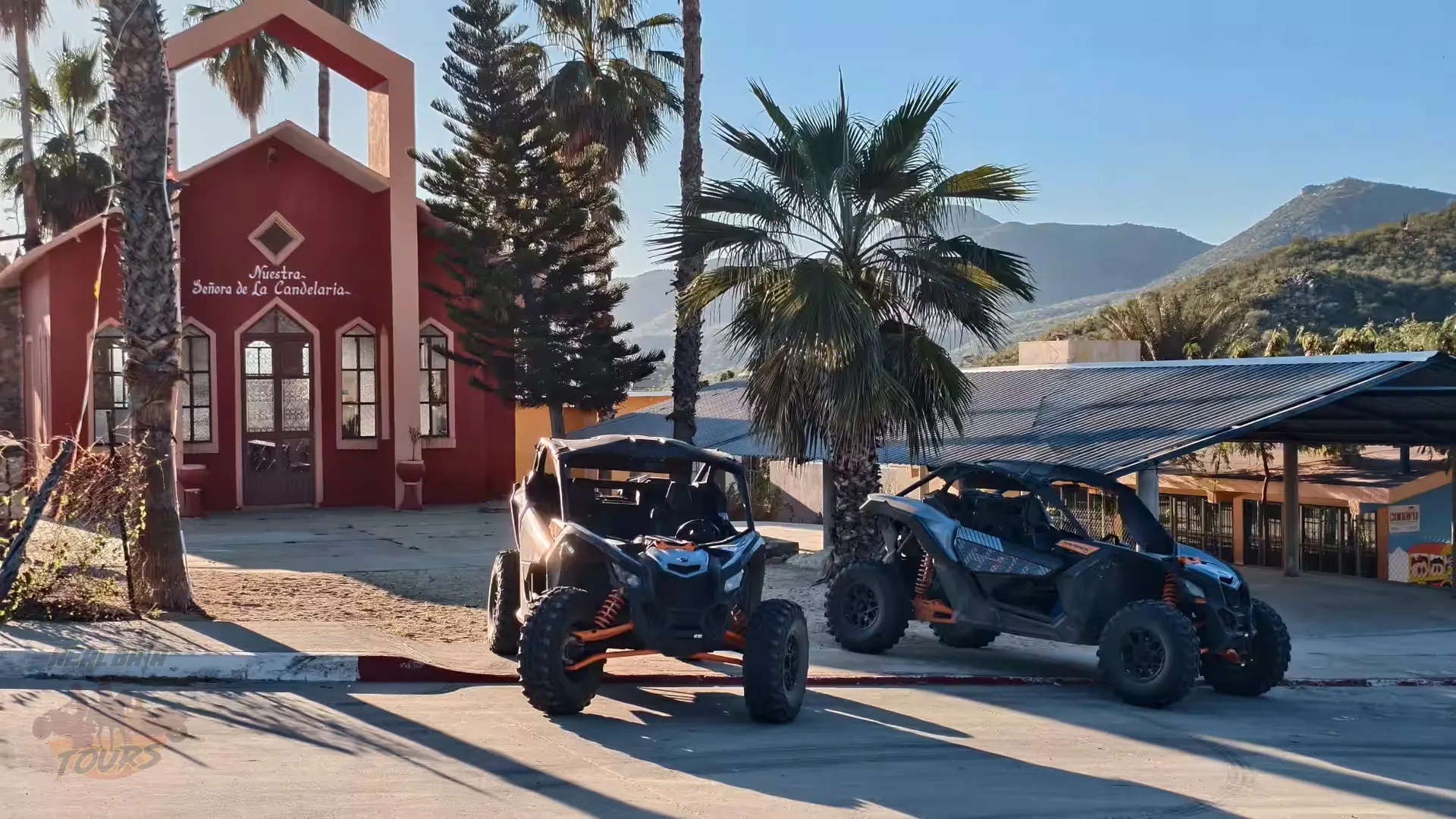 ATV buggies parked at red chapel near candelaria with mountains and palm trees in Baja California Sur ATV buggies parked at red chapel near candelaria with mountains and palm trees in Baja California Sur