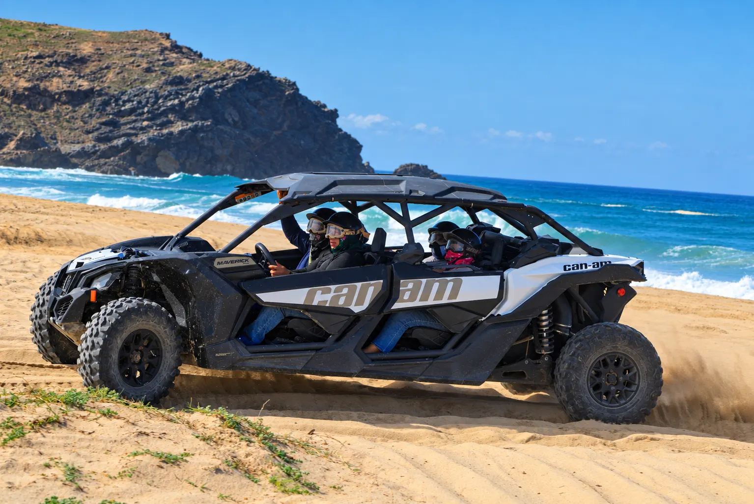 Quadruple X3 Can-Am Maverick with four riders on the beach in Cabo San Lucas
