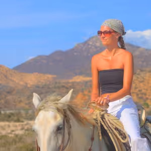 Woman on horseback with the Baja California mountains behind her