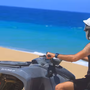 ATV rider pausing to take in the turquoise Pacific Ocean view