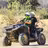 Two jinetes en an ATV in Baja California Sur desert with sandy terrain and vegetation
